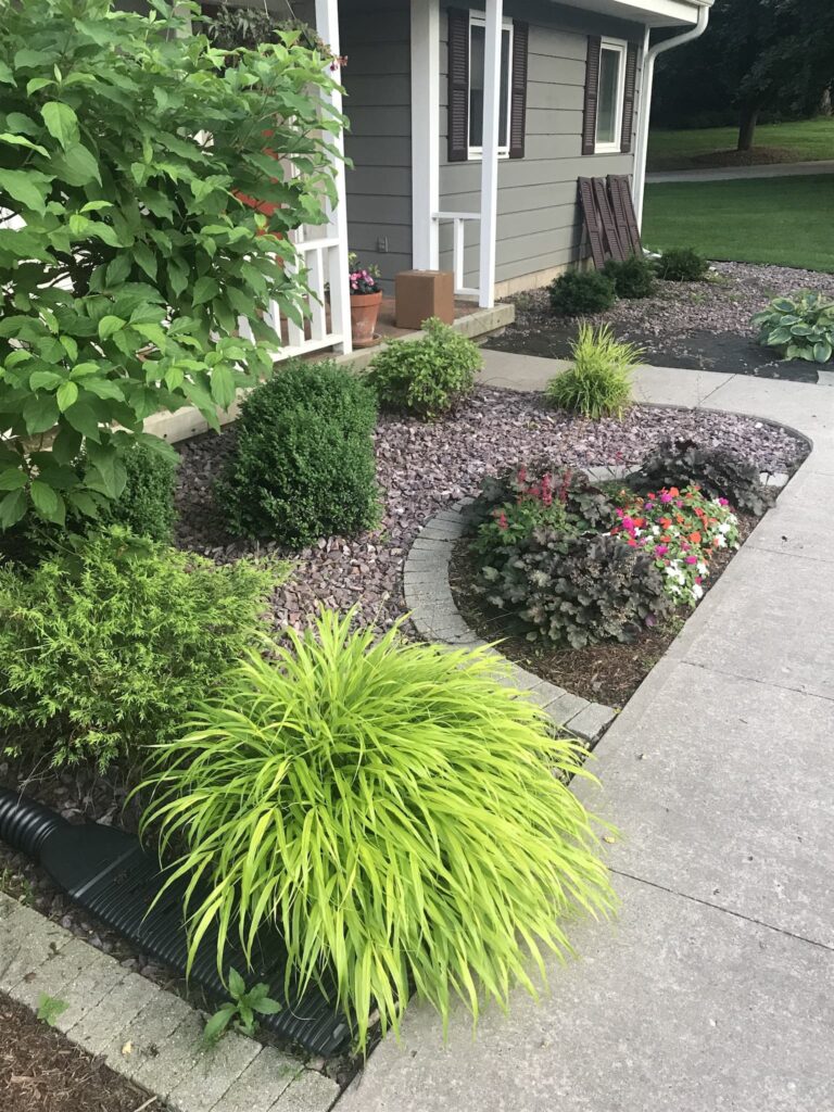 Residential front yard with landscaped garden and walkway.